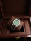 Luxury men's silver wristwatch with green dial in a wooden display box at Ministry of Mens Affair