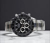 Luxury men's stainless steel chronograph watch with black dial on marble surface