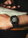 Luxury men's watch with black rubber strap and skeleton dial worn on wrist, Ministry of Mens Affair